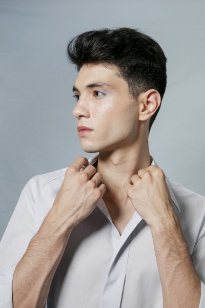man posing while holding shirt collar 1